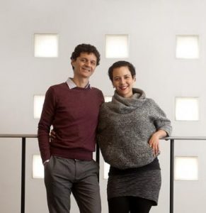 an image of a man and a woman standing together with warm clothing on their bodies